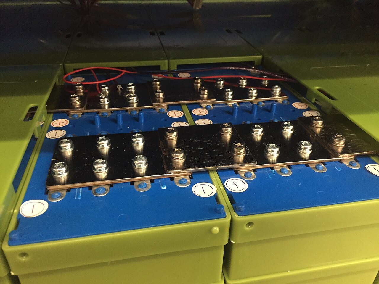 Prismatic lithium-iron-phosphate cells bolted together with copper bus bars.