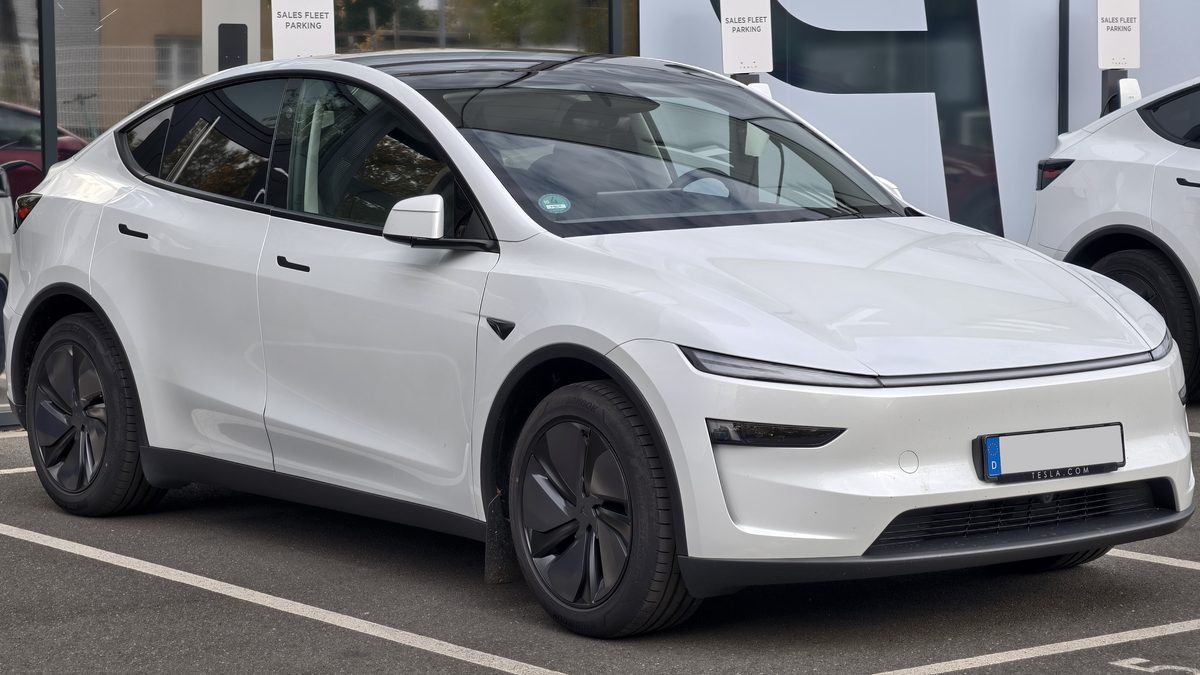 White Tesla Model Y Premium facelift, front three-quarter view, parked.