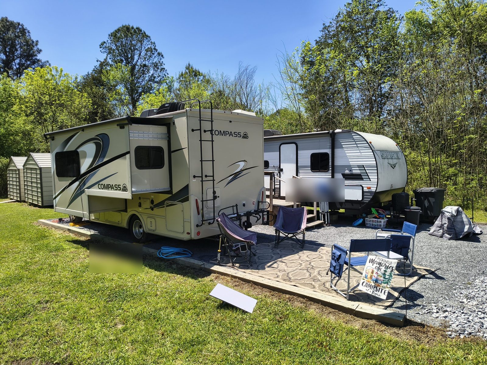 Two RVs parked side by side on gravel pad in Tennessee - dual workspace boondocking office setup with camp chairs