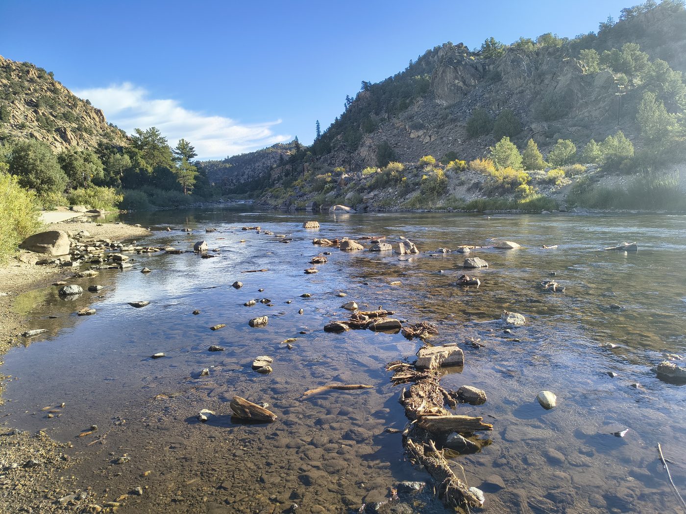 Arkansas River shoreline with clear water and rocks at Hecla Junction