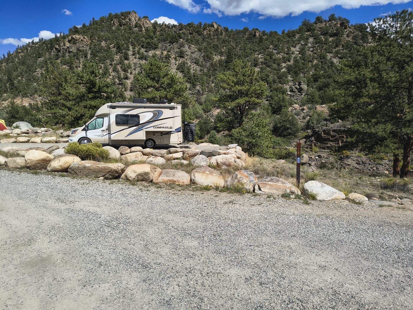 Thor Compass AWD on gravel pad at Hecla Junction with mountain slope behind
