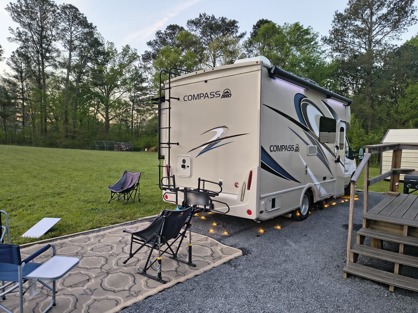 Thor Compass AWD motorhome at a grassy campsite with the Starlink dish set out on the lawn