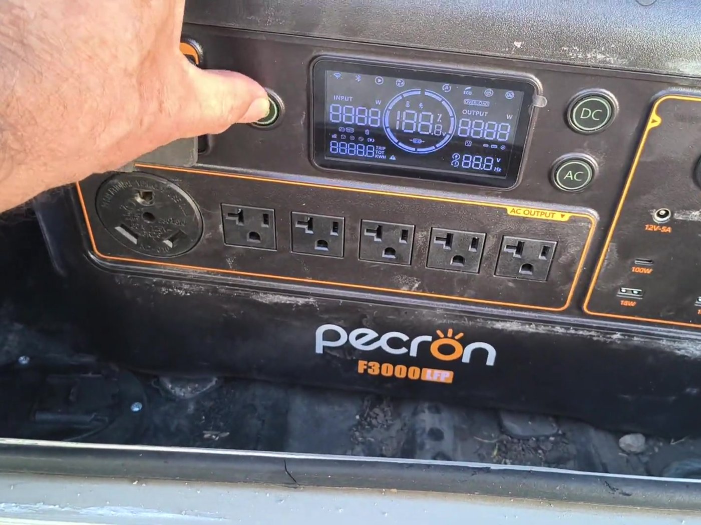 Pecron F3000 power station control panel powering on in the RV storage bay, Starlink router cable plugged into one of its AC outlets