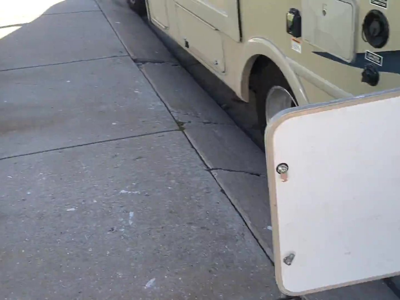 RV storage bay door open next to the wheel well, where our power station and router normally live